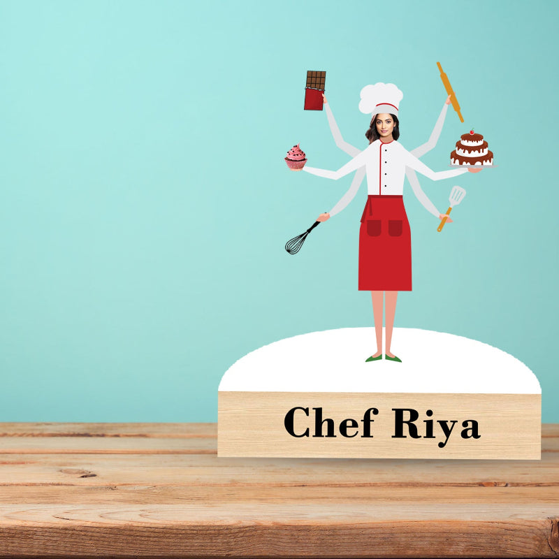 Figurine of a chef with multiple arms on a wooden base with 'Chef Riya' text against a light blue background.
