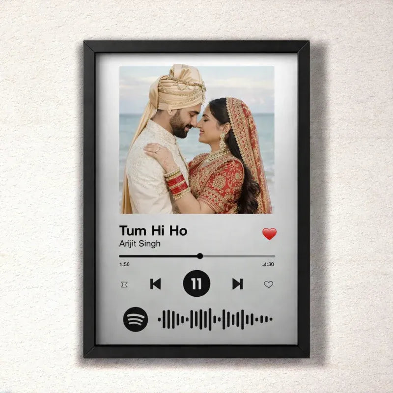 Framed artwork of a couple in traditional attire with a music player interface design on a textured wall.
