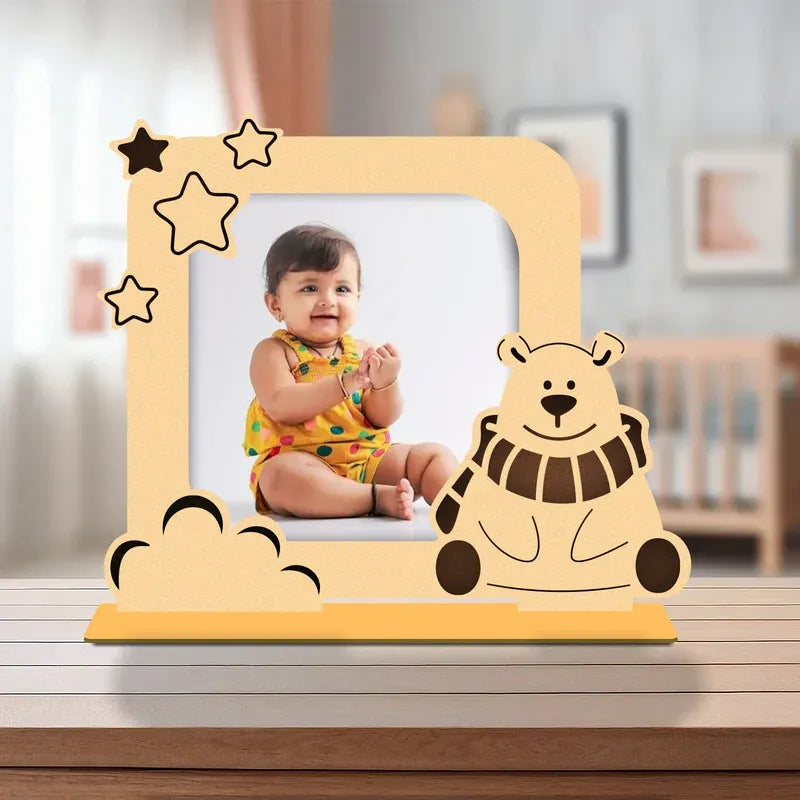 Wooden photo frame with a bear design on a surface, featuring a child's photo inside.