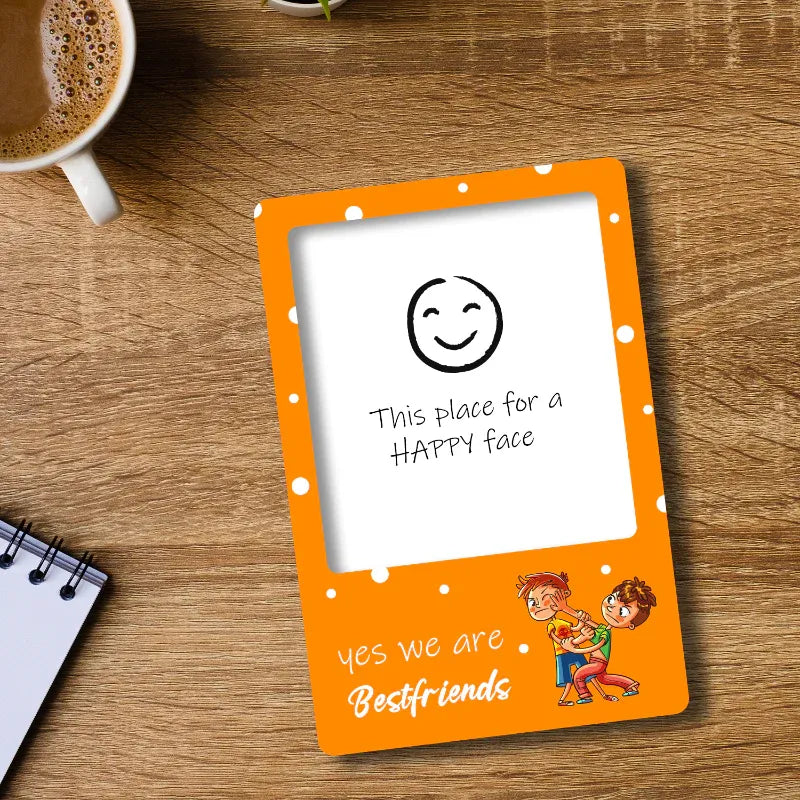 gift for friends fridge magnet frame with a white center for a 'HAPPY face' on a wooden surface with a cup of coffee and notebook.