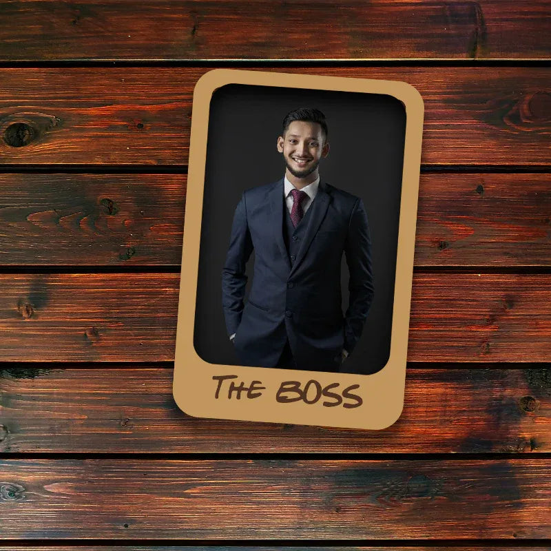 Man in a suit with 'THE BOSS' text on a wooden background