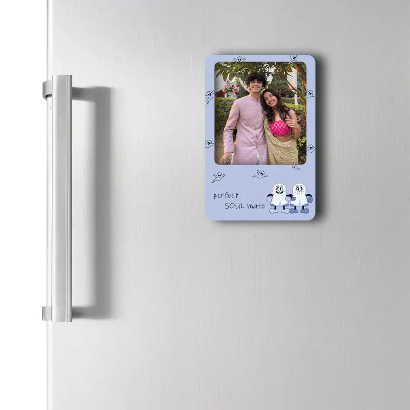 Framed photo of a couple on a refrigerator with decorative border text.