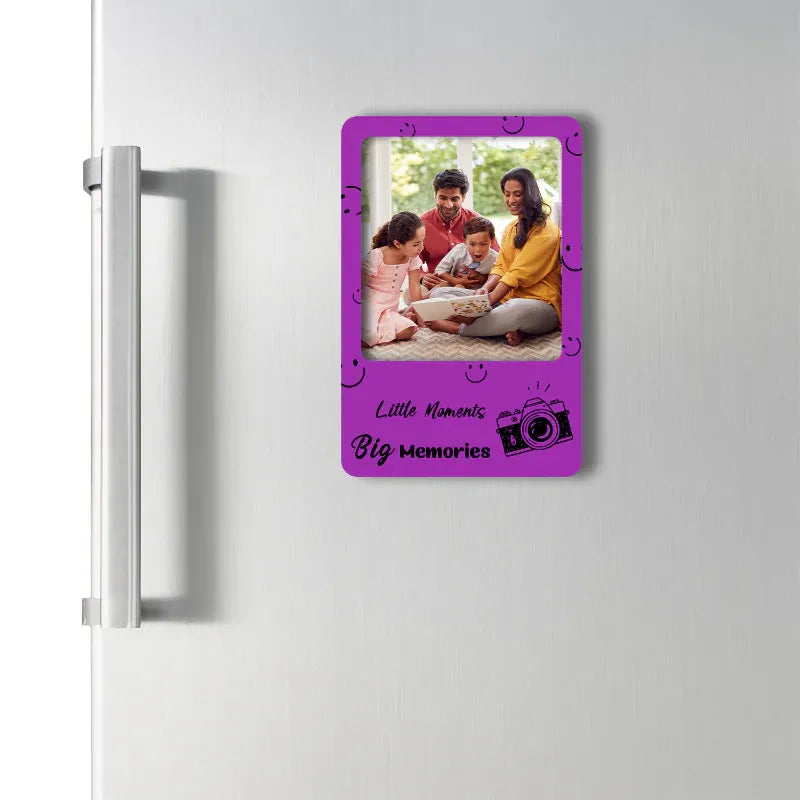 Purple photo frame magnet on a refrigerator with a family photo inside, featuring the text 'Little Moments Big Memories'.