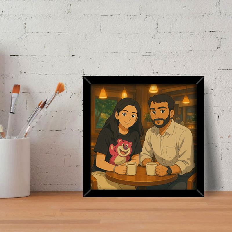 Framed artwork of a couple sitting together with a bear graphic on a table against a white brick wall.