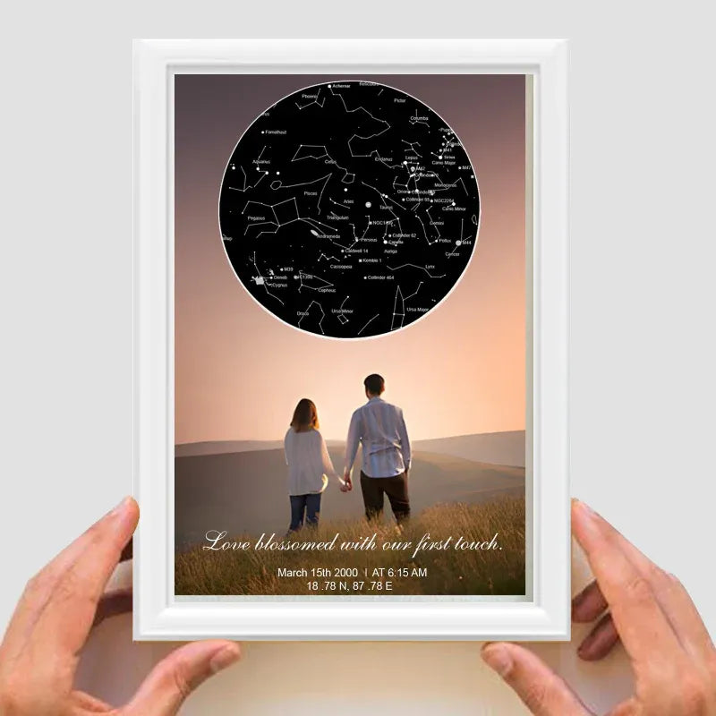 Framed star map with a couple's photo and personalized text on a light gray background