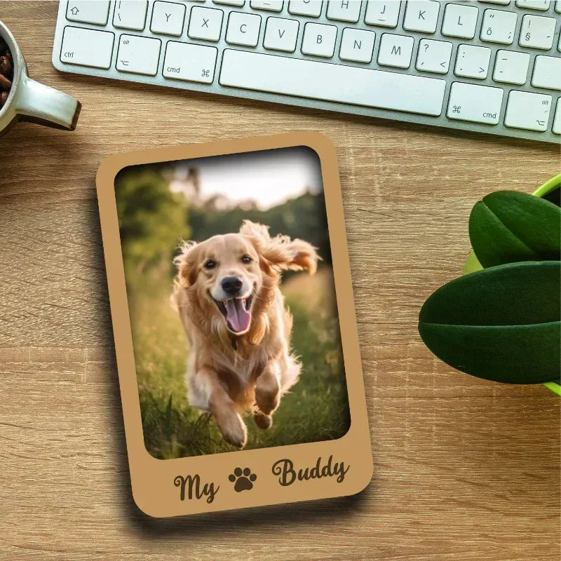 Wooden photo fridge magnet with a dog picture on a desk with a keyboard and mug.