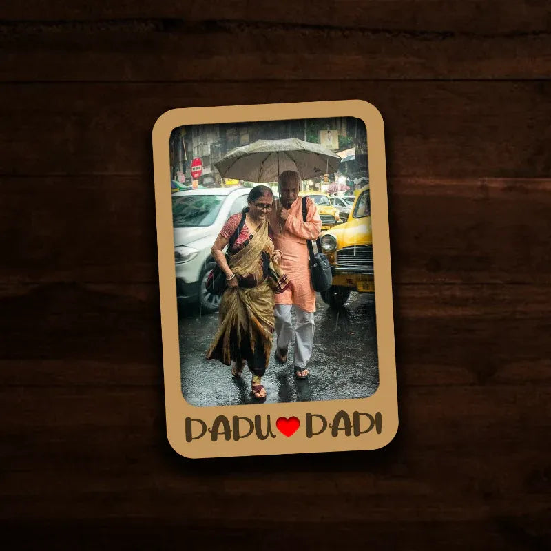 Memorable moment between a 'Dadu' and 'Dadi' with a heart symbol on a wooden background fridge magnet