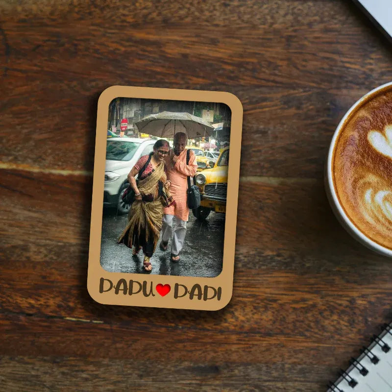 Memorable moment between two people with a heart and text 'DADU LOVE DADI' on a wooden surface with a cup of coffee.