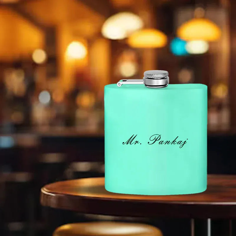 A custom hip flask with a silver cap and with the text 'MR. Pankaj' on the front.