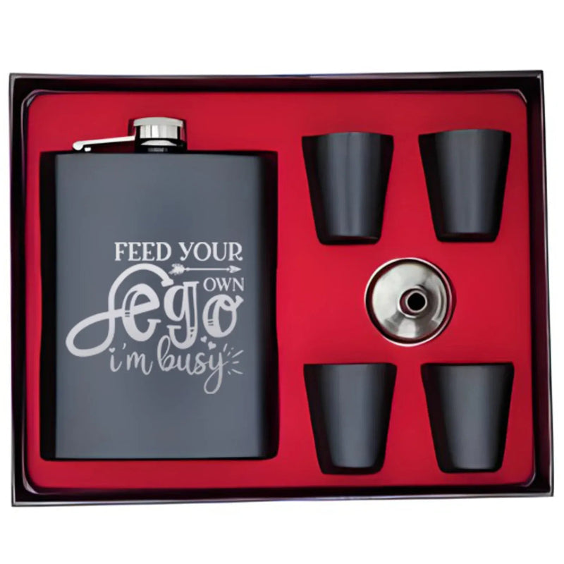 Flask set with four black cups and a silver cap on a red interior background