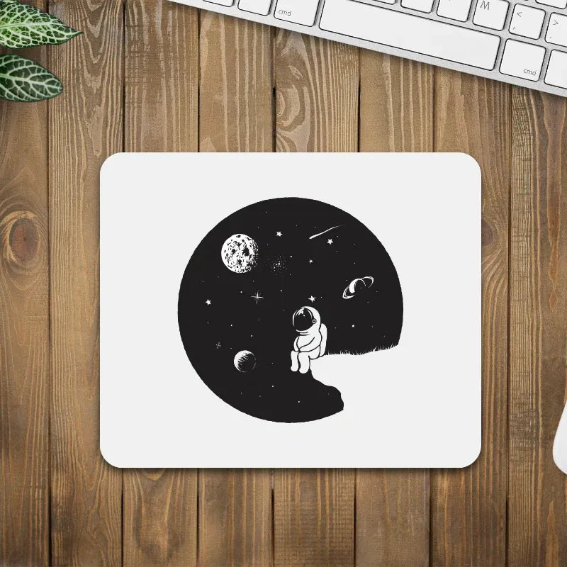 Mouse pad with an astronaut design on a wooden desk