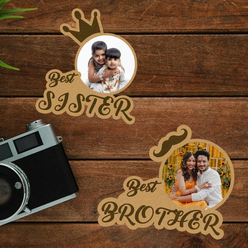 Two decorative signs with photos of a sister and brother, a vintage camera on a wooden surface.