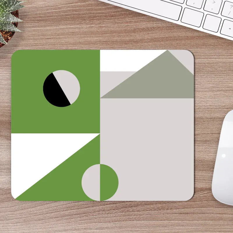 Geometric mouse pad on a wooden desk with a keyboard and mouse.