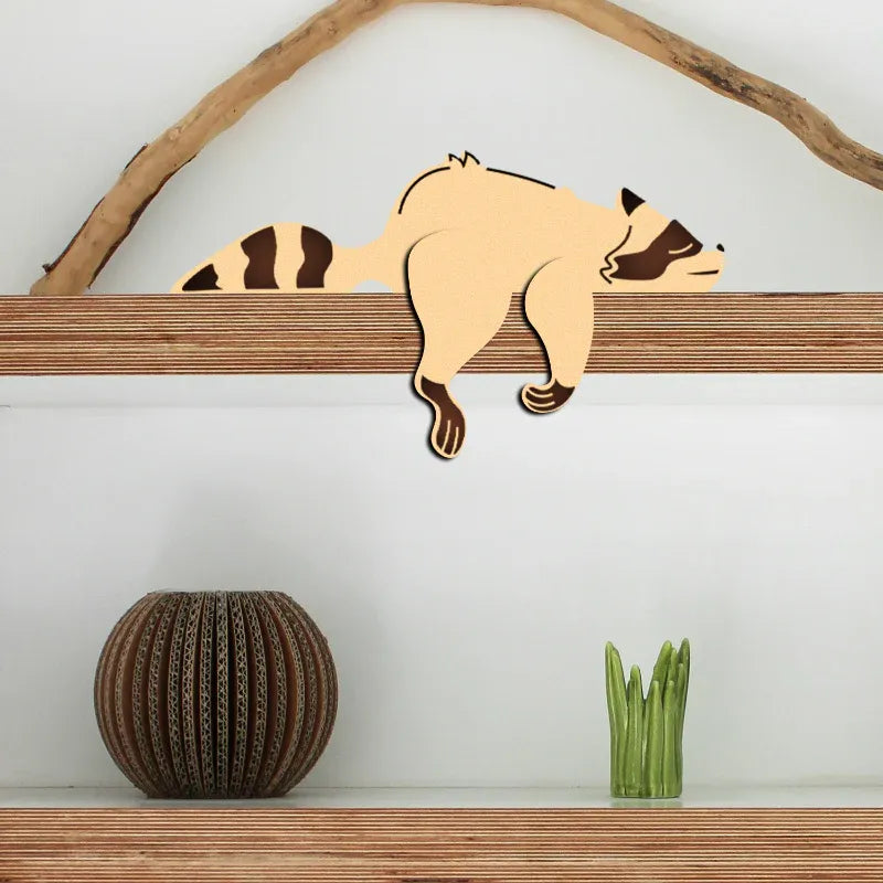 sleeping raccoon shelf sitter decor hanging over edge legs dangling handcrafted showpiece — Zingy Gifts