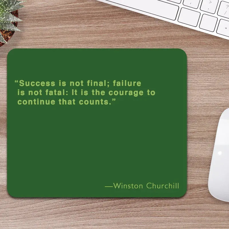 Green mouse pad with Winston Churchill quote on a wooden desk