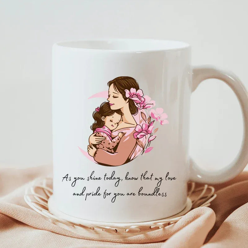 White ceramic mugs with a mother and child illustration and a quote on a light background
