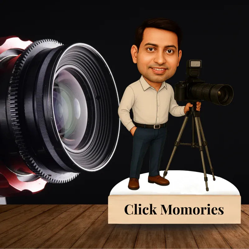 Bobblehead of a man holding a camera with camera lens and 'Click Momories' text on a wooden surface.