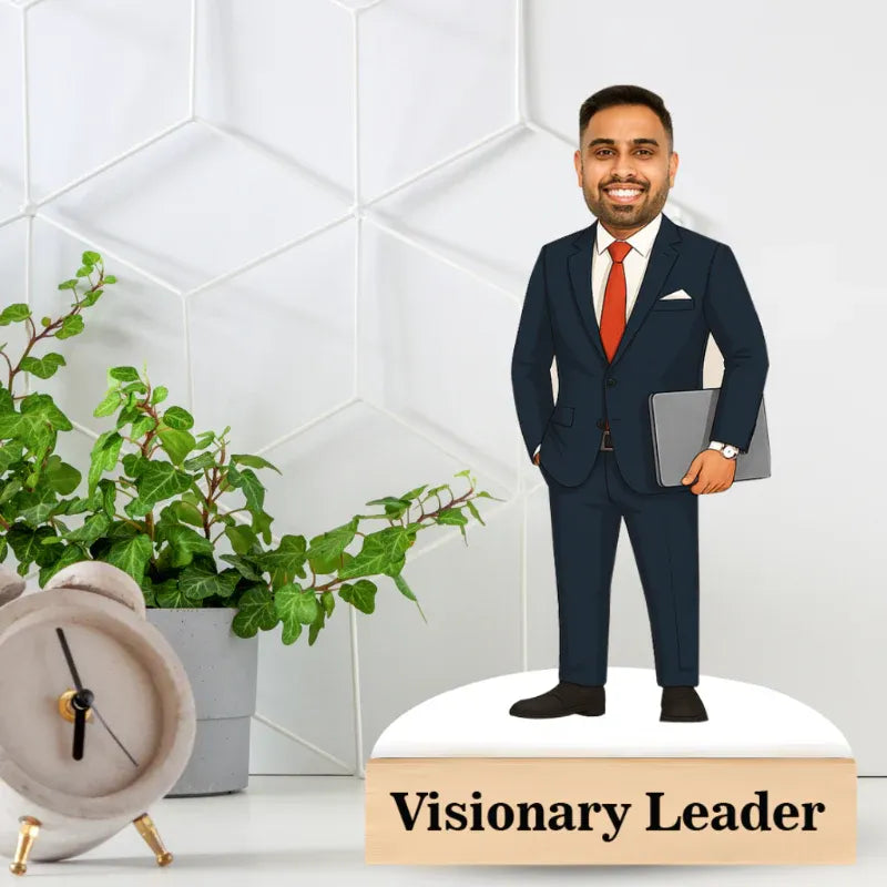 Mannequin of a man in a suit holding a tablet with 'Visionary Leader' text, against a white geometric wall.
