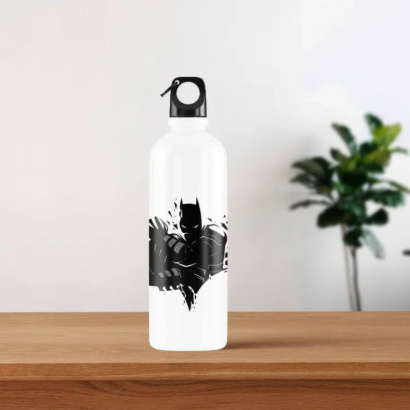 White water bottle with black batman design on a wooden surface with a plant in the background