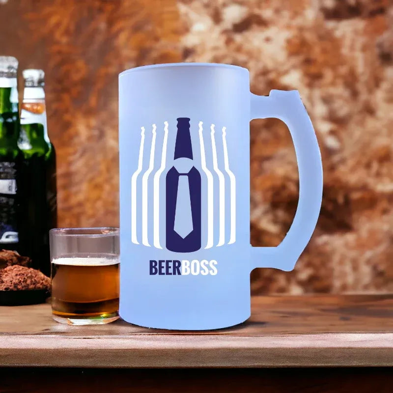 Blue mug with 'Beer Boss' design next to a glass of beer on a wooden surface.