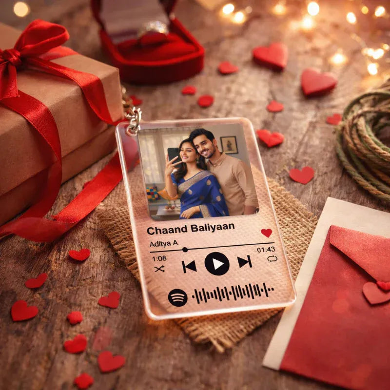 Spotify album cover with a couple's photo on a wooden surface with heart decorations