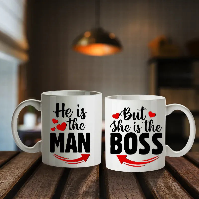 Two mugs with humorous text design on a wooden surface.