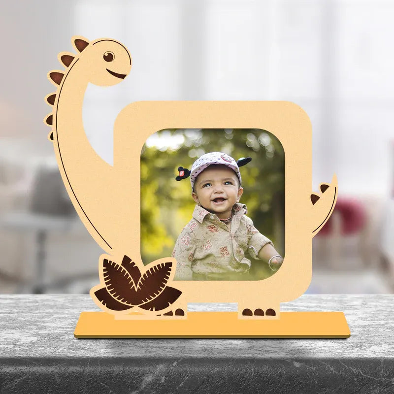 Wooden dinosaur-shaped photo frame with a picture of a child on a blurred background