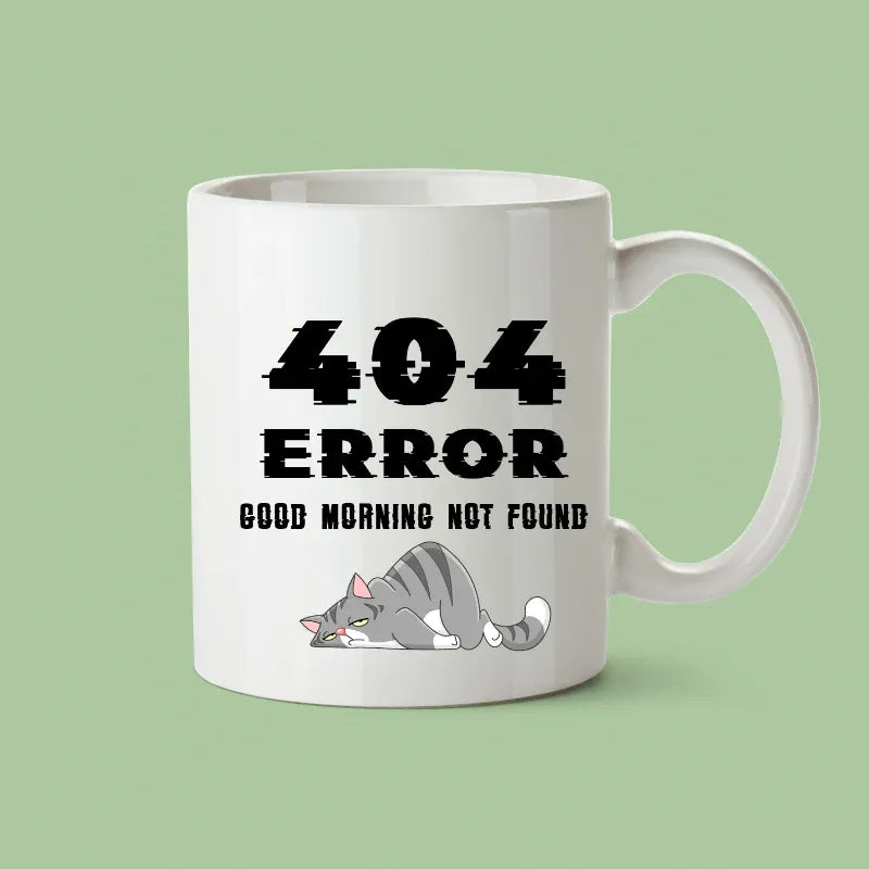 White mug with '404 Error Good Morning Not Found' text and a cat illustration on a green background