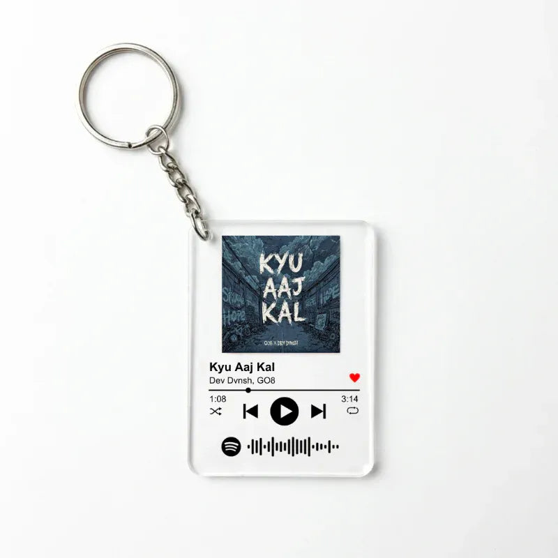Keychain with music player design and text 'KYU AAJ KAL' on a white background