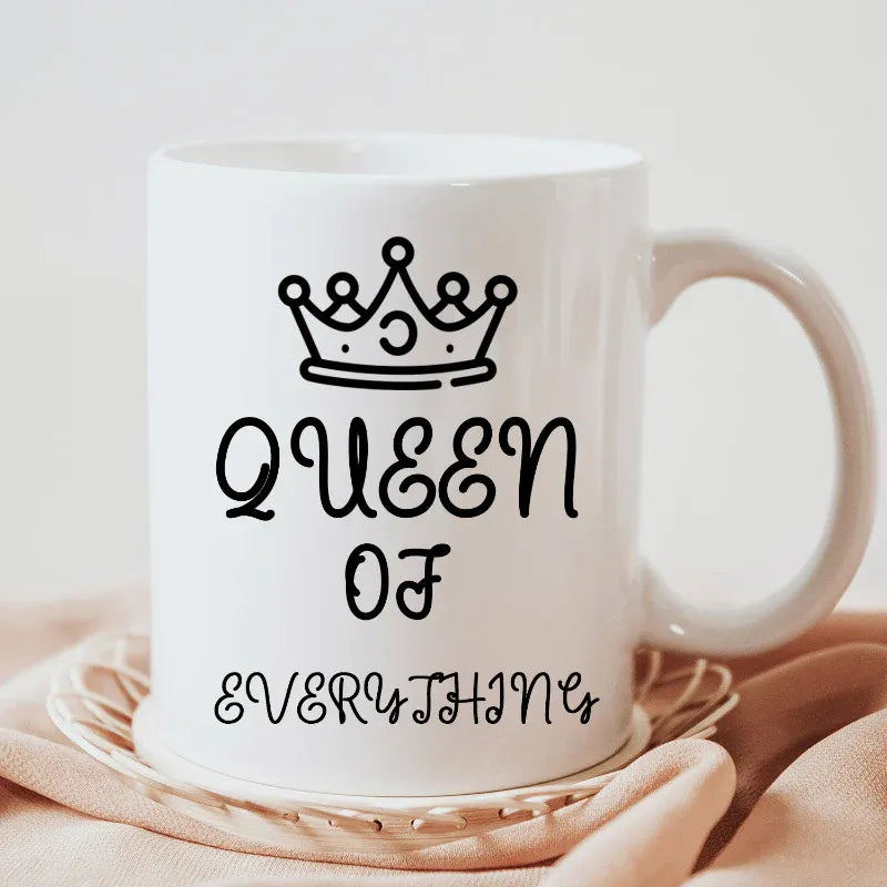 White personalised mugs for daughter's day with 'Queen of Everything' text and crown design on a beige background