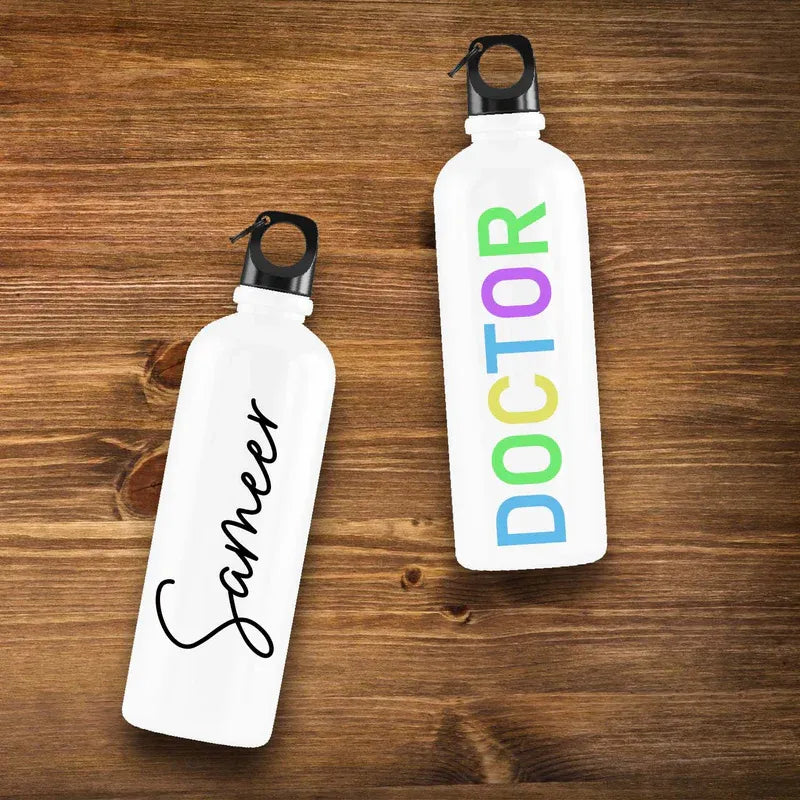 Two white water bottles with personalized text on a wooden surface