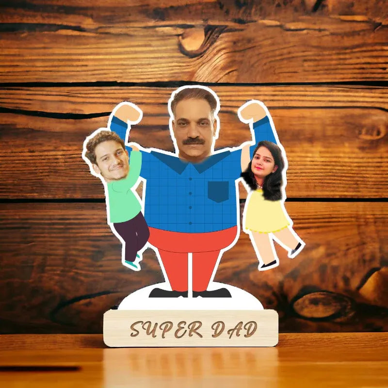 Cardboard cutout of a father with two children on a wooden stand labeled 'Super Dad' against a wooden background.