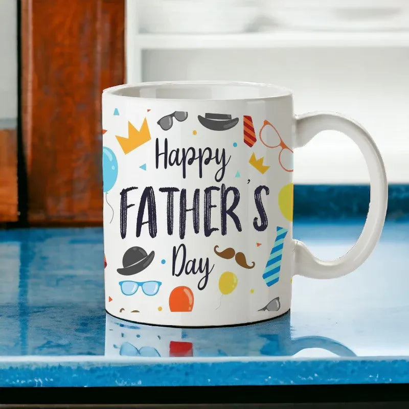 White mug with 'Happy Father's Day' text and colorful graphics on a blue surface.