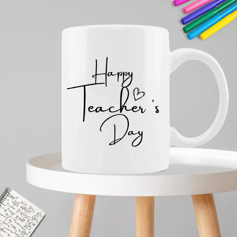 White mug with 'Happy Teacher's Day' text on a gray background