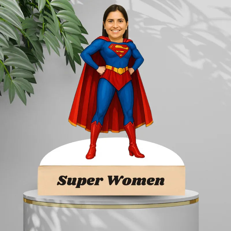 Superwoman caricature on a wooden stand with 'Super Women' text, against a light gray background with plant leaves.
