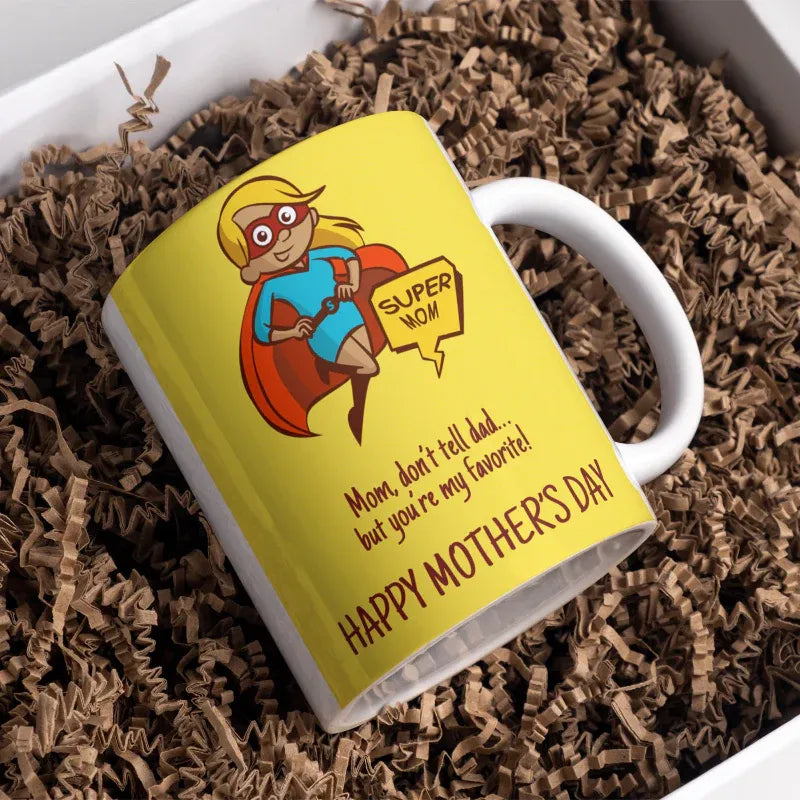 Mug with superhero mom design and text on a brown crinkled paper background