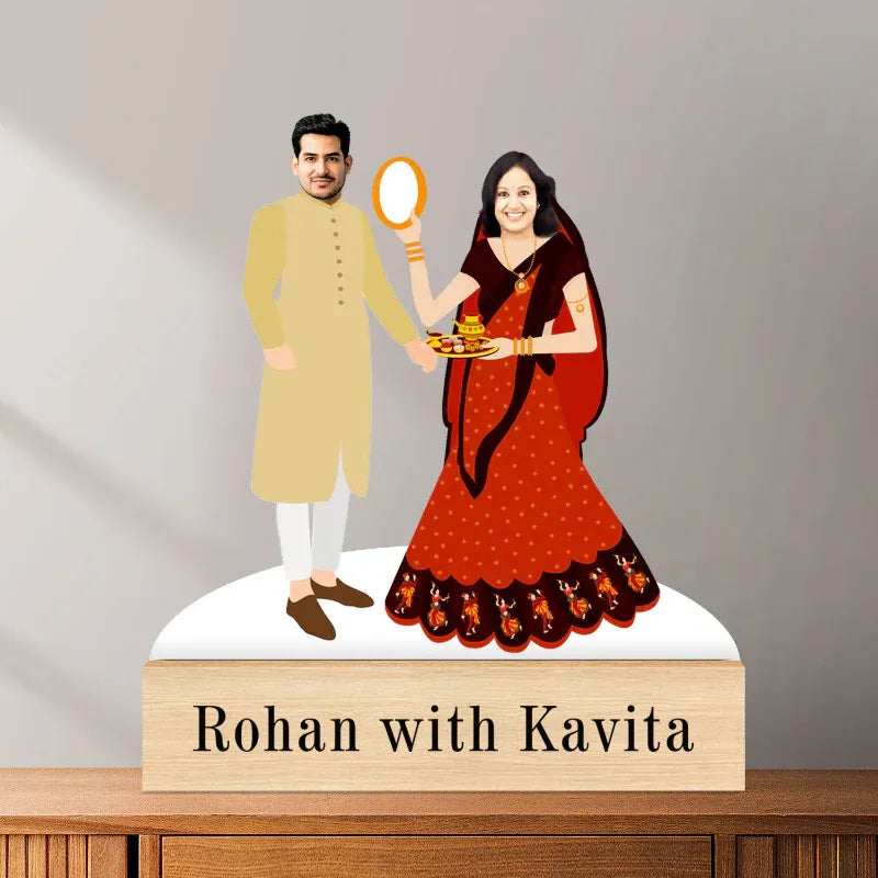 Decorative figurine of a man and woman in traditional attire with 'Rohan with Kavita' text on a wooden base.