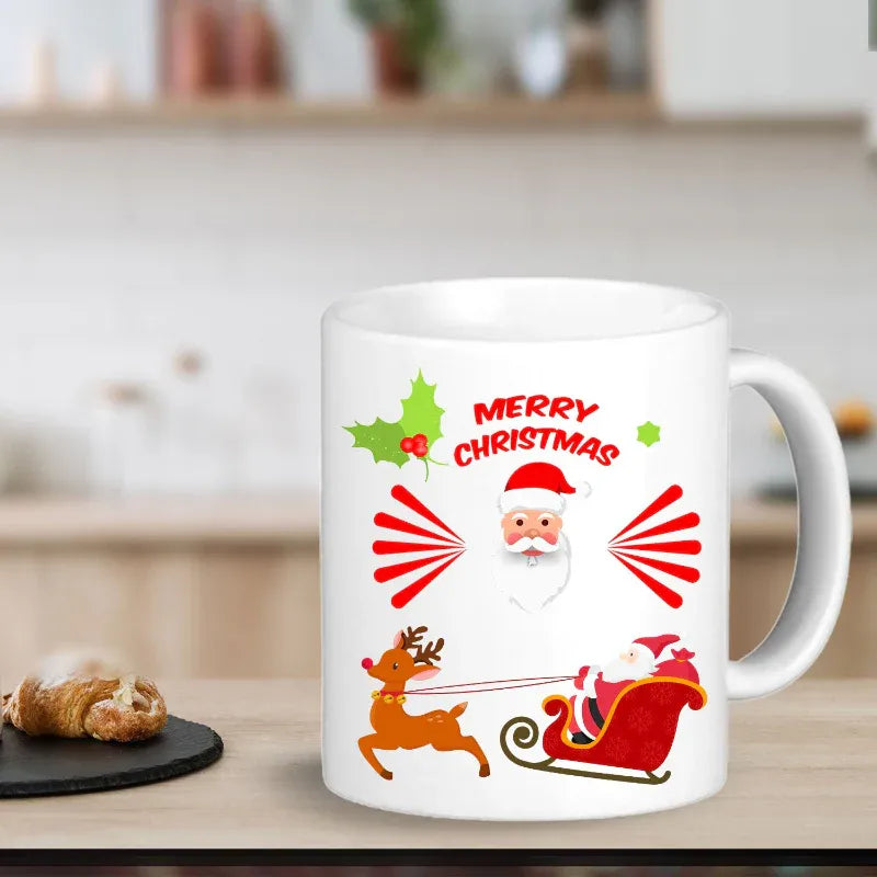 White mug with Christmas design featuring Santa Claus, reindeer, and 'Merry Christmas' text on a blurred kitchen background.