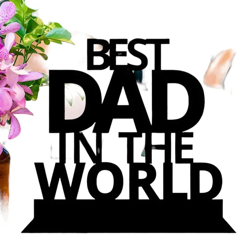 A wooden table top with the inscription 'BEST DAD IN THE WORLD' in black letters, placed on a white surface.