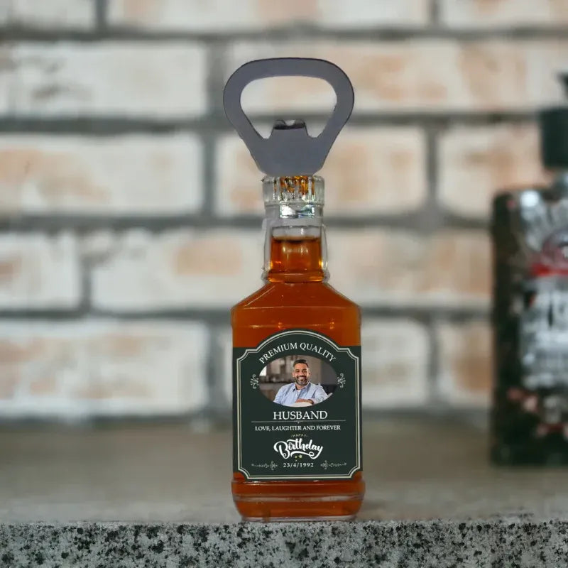 Bottle of alcohol with a bottle opener on top, labeled 'Husband', against a brick wall background.