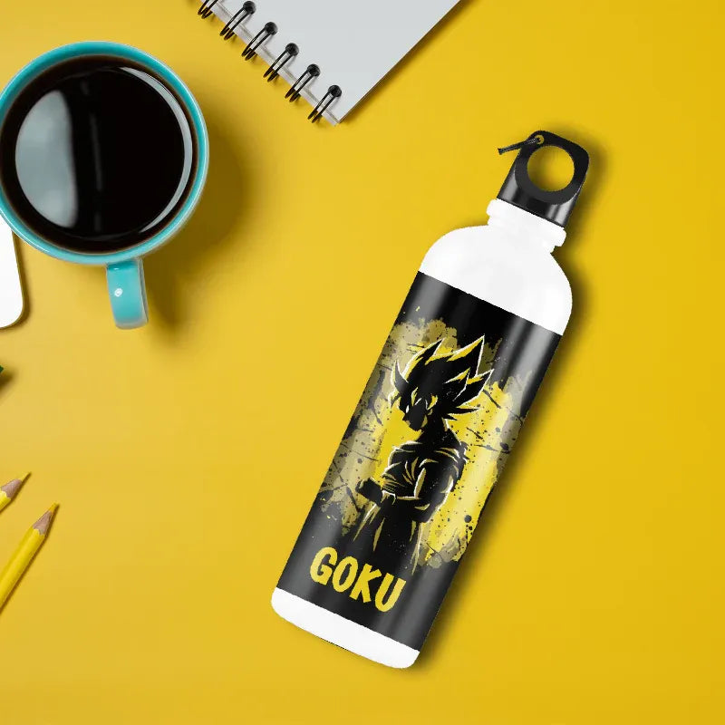 Water bottle with 'Goku' design on a yellow surface with a cup of coffee and pencils.