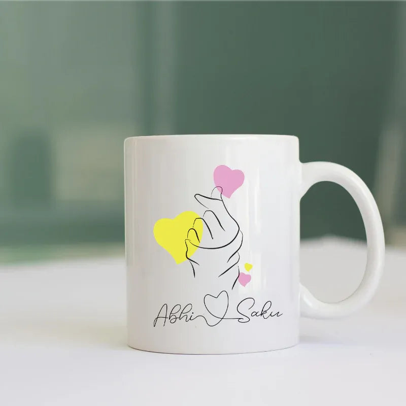 White mug with artistic design and text on a blurred background
