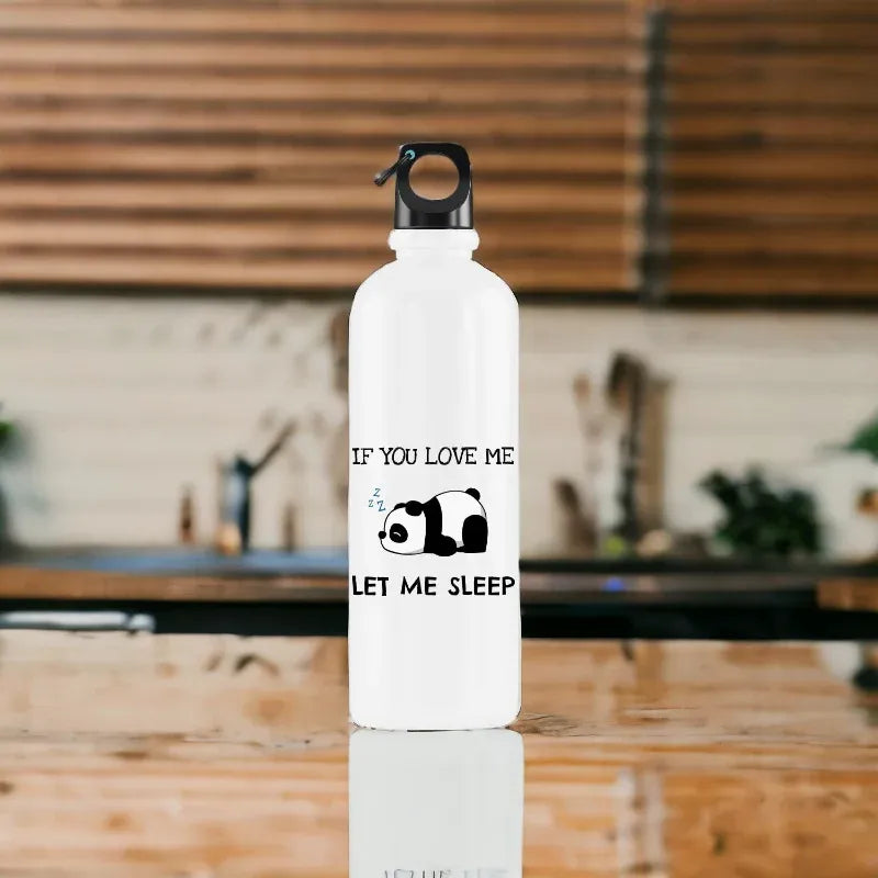 White water bottle with text and panda design on a reflective surface with a blurred background