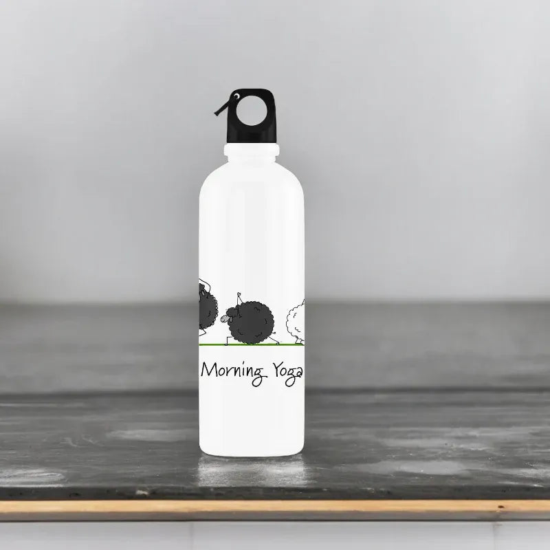 White water bottle with black and green design on a wooden surface