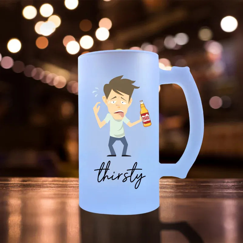 Blue mug with cartoon character and 'thirsty' text on a blurred bar background