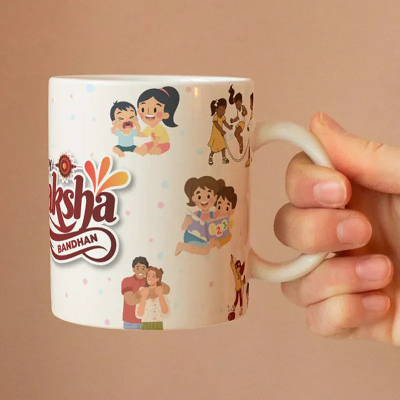 Mug with illustrations of children and 'RAksha Bandhan' text held by a hand against a beige background