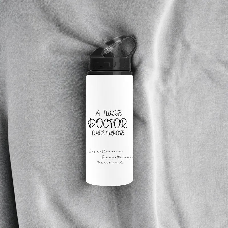 White water bottle with black text on a gray fabric background