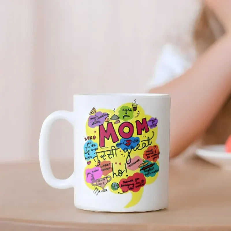White mug with colorful 'Mom' design on a wooden surface