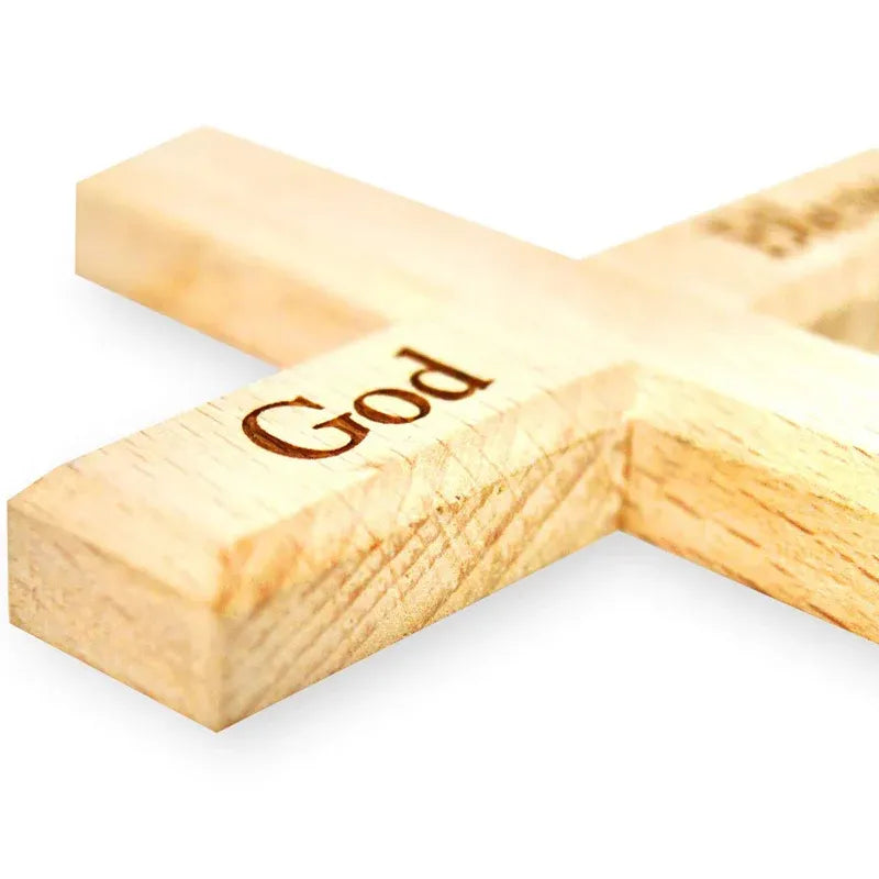Wooden cross with 'God' engraved on a white background