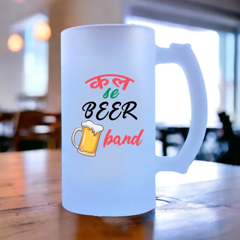 Frosted mug with colorful text and beer graphic on a blurred background